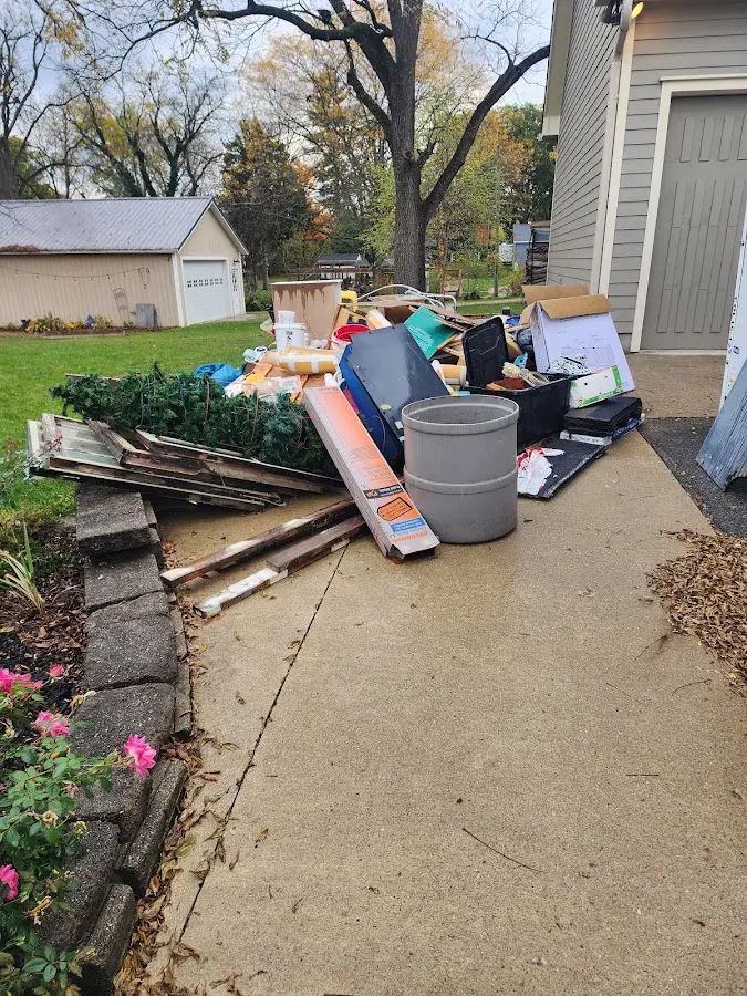 Dumpster being loaded with debris for Estate Cleanout Dumpster Rental in Fort Myers Shores